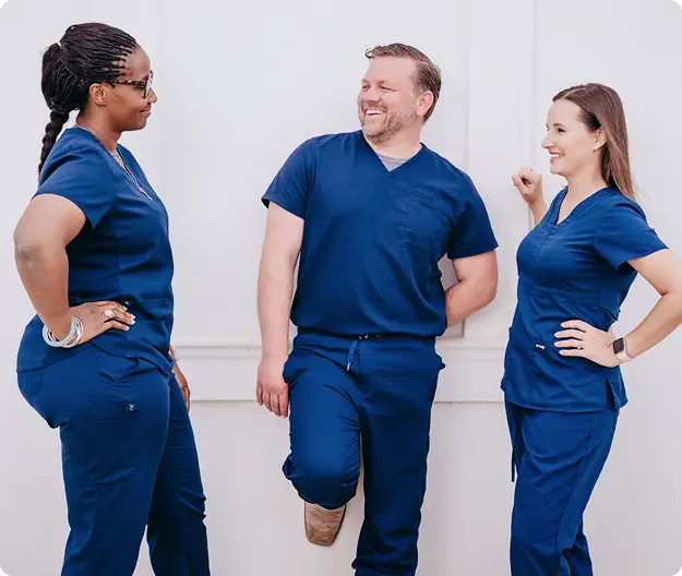 Three Amity nurses smiling together.